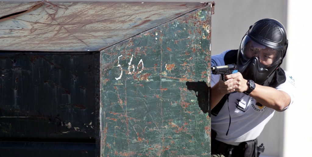 Sheriffs Department Security Officer Yiwei Wang peeks around a dumpster at the Active Shooter event held at Old Plant Facilities building at Pierce College Woodland Hills, Calif. Wednesday Feb 1, 2012. Photo: Jose Romero