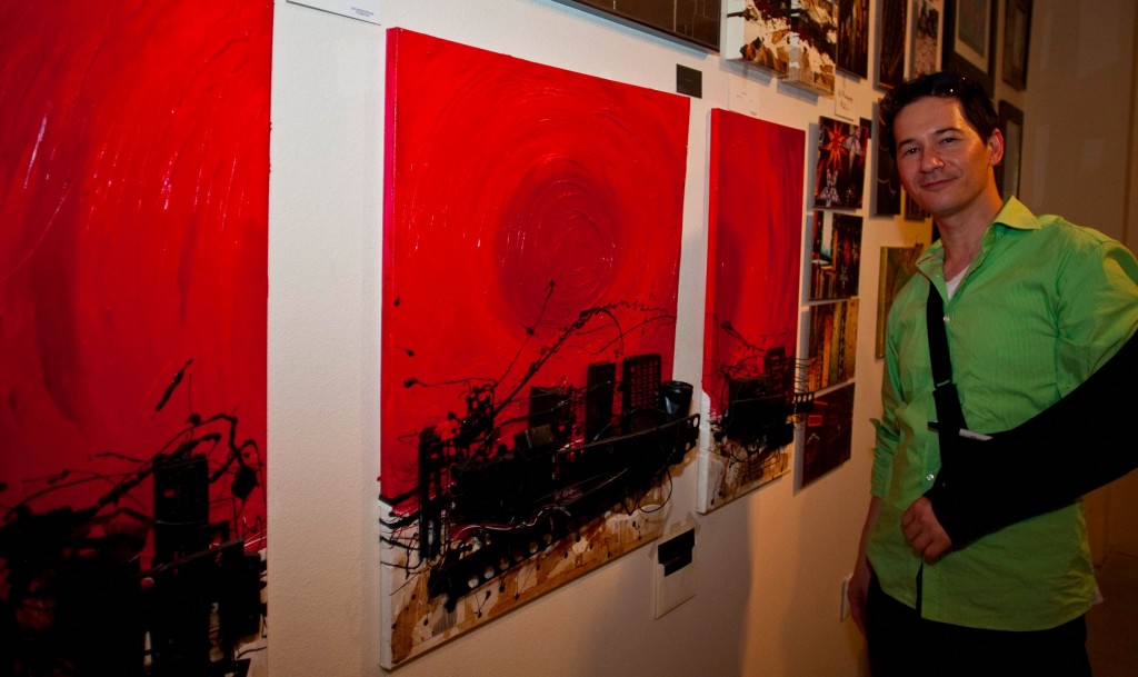 Mixed media artist Andrew Ko displays his three-dimensional triptych painting entitled "Dead City Full Trip" during the Canoga Park ARTrageous Art Walk in Canoga Park, Calif. on July 20, 2012. 