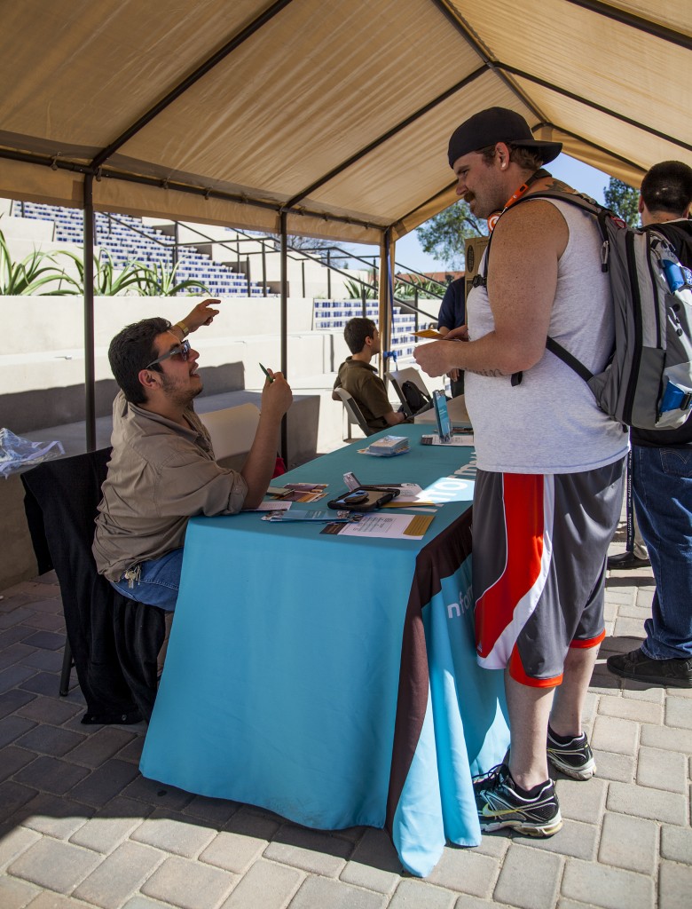 Volunteer David DeLoya, sets an appointment for Dustin Elliott, a youth pastor, who is taking advantage of help offered under Covered California Week, in front of the library of Pierce College. Monday Feb. 24, 2014 Woodland Hills, Calif. Photo: Lynn Levitt.