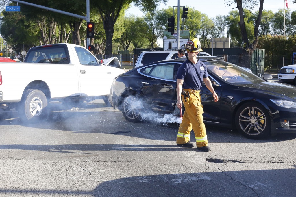 Firefighter sets flares to ward off on-coming traffic at the scene of an accident on the Victory and Winnetka intersection, at Pierce College, Woodland Hills, March 12, 2014.