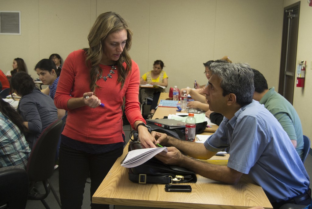 Jamie Ray and Morhsen Arasteh(cq) dealing with homework corrections in classroom 8400A within the Village of Pierce College in Woodland Hills, Calif. on Wednesday, April 23, 2014. She is helping Mohsen with the corrections. Photo: Marc Dionne