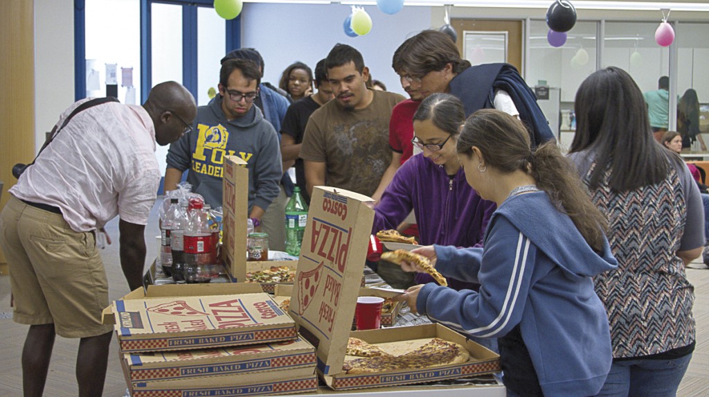 Students line up to grab  pizza during Student Celebration Day. The ASO organizes the event in their office, as part of the end of semester celebrations. May 14, 2014. Photo: Erick Ceron
