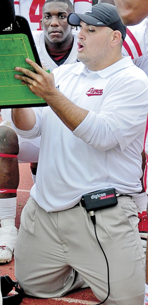 The Defensive coach Juan Navarro talks to his players during the American Division Championship game last Fall against Chaffey College. Photographer: Carlos Carpio