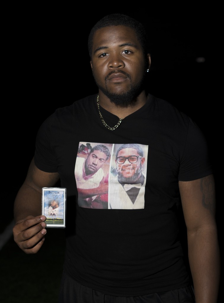 James Dinson wears a memorial shirt and  keeps a photograph of his brother Dejour Benson in his sock . Benson was fatally struck by a car in March of  last year, he passed away at the age of 17 - years old. Photo: Diego Barajas