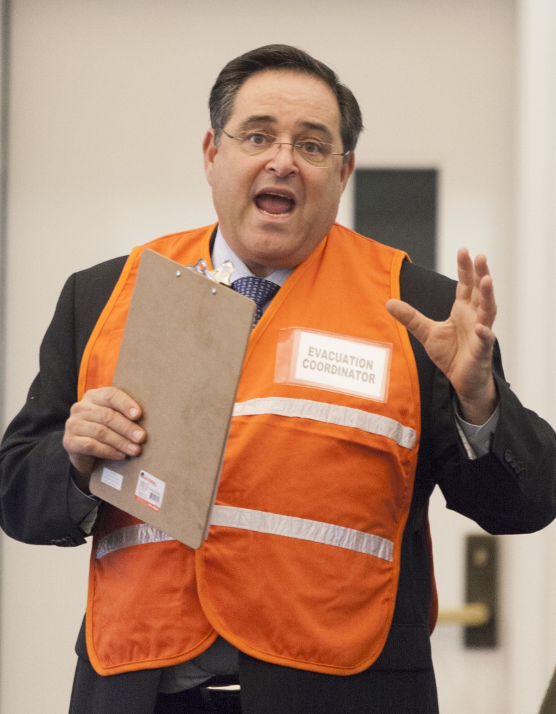 Pierce College Associate President Larry Kraus displays the  new evacuation cordinator vest at the Academic Senate meeting that will be given to selected people in in different buildings on campus incase of an evacuation on Monday  Dec. 1, 2014. Photo: Diego Barajas