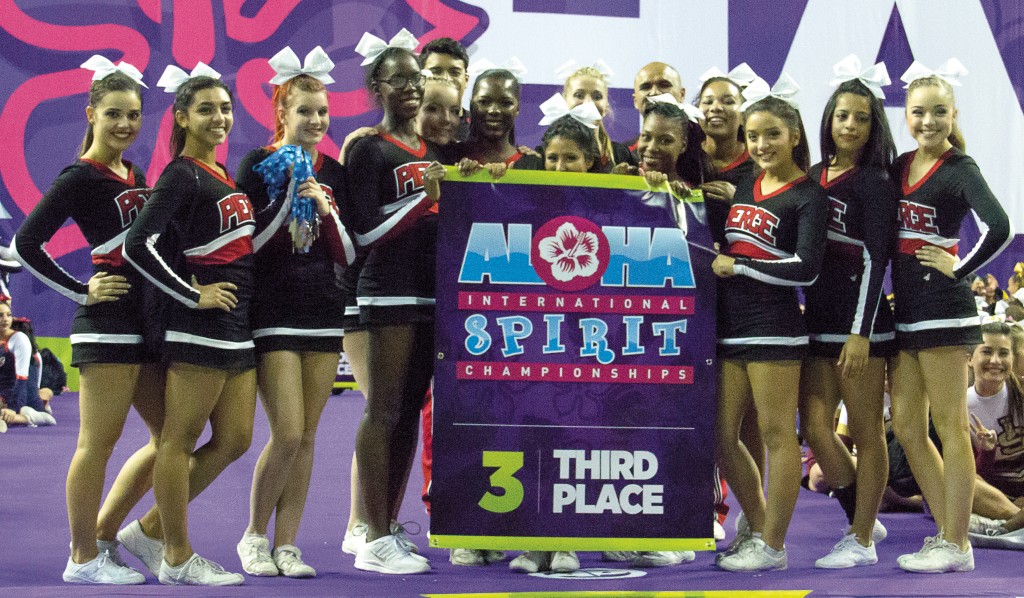 Pierce College's cheerleading competition team holds up its third place banner after competing against California Baptist University and USC on Saturday, March 14 at USC. Photo by: Alan Castro