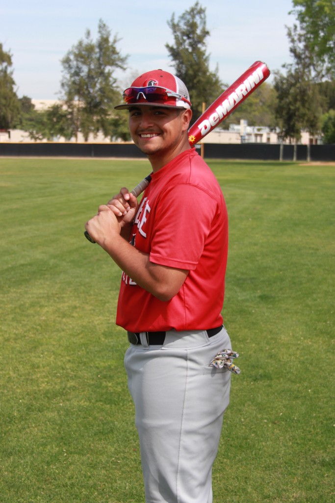 Sophomore first baseman Christian Mercado takes a break from practice. Photo by: Megan Moureaux 