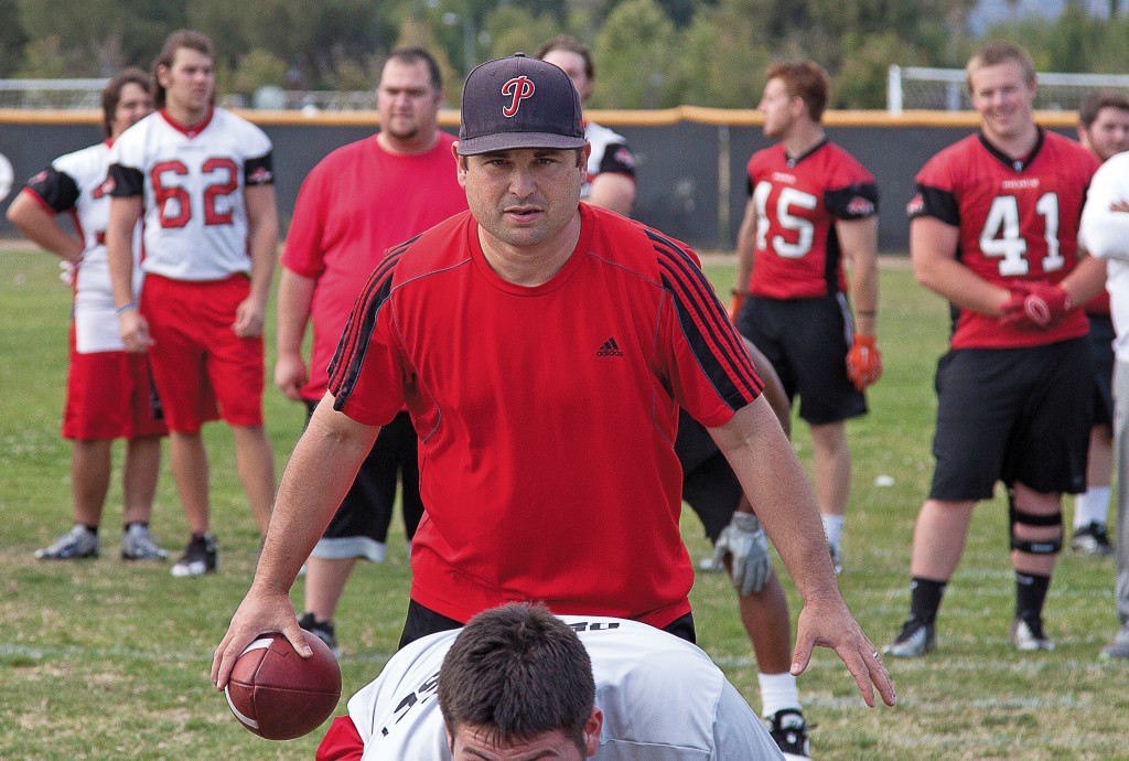 Football head coach Jason Sabolic leads offensive drills as other members of the team observe on Thursday, May 21. Woodland Hills, Calif. Photo: Mohammad Djauhari