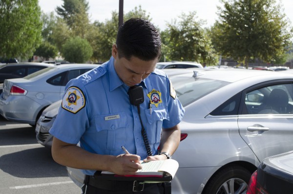 Cadet Andrade of the Los Angeles Community College District of the Los Angeles Sheirff's Department, writes a ticket for vehical without a parking permit in Parkting Lot 2 on Sept. 14th, 2015 at Pierce College Woodland Hills, Cali. Today is the first day of parkting permit enforcemnet. Photo by: Christopher Mulrooney