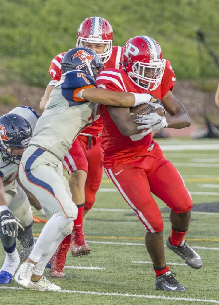 Number 3 Calvin Howard keeps running forward while number 7 Derrick Worhty tries to bring him down during the Brahmas game against Orange Coast College on Oct. 10, 2015 at John Shephard Staidum at Pierce College, Woodland Hills, Calif. The Brahmas would lose 35-7 against the Pirates. Photo by: Gustavo Sanchez