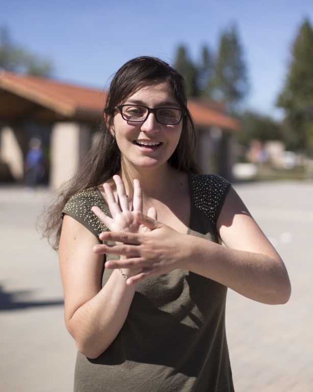 American Sign Language major Tori Maddis shows the sign for “movie” on the Pierce College Mall on February 24, 2016 in Woodland Hills, Calif. Photo: Travis Wesley