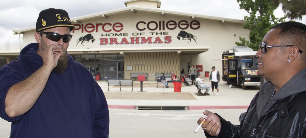 Pierce College students Drew "Big Sexy" Stern, 27, and Brian Humpay, 27, smokes a cigarette with a tar filter  in the faculty and staff parking lot in front of the South Gym on Thursday, May 5, 2016 in Woodland Hills, Calif. (Photo by: Alan Castro)