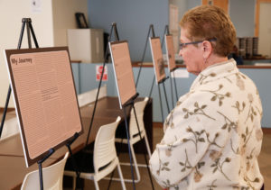 Paula Paggi, Pierce Librarian, looks at an informational board at the Foster Youth Exhibit, hosted by the Guardian Scholars Program and CAFYES, on Nov. 21, 2016 at Pierce College in Woodland Hills, Calif.