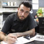 Jared McFarland sketches in his spare time at work on Nov. 4, 2016 at L&G Tattoo in Panorama City, Calif. McFarland is an art major at Pierce College, works as a tattoo artist. His ultimate goal is to become a museaum currator so that he can spread his love and appreciation of art to others. Photo by Taylor Arthur
