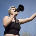 Melissa Robles, Chair of the Movimiemto Estudiantil Chicano de Aztlan (MEChA), stands by the bull on the Mall and speaks to students, faculty, and staff during a walkout and protest on Nov, 16, 2016 at Pierce College in Woodland Hills, Calif. Photo by Taylor Arthur