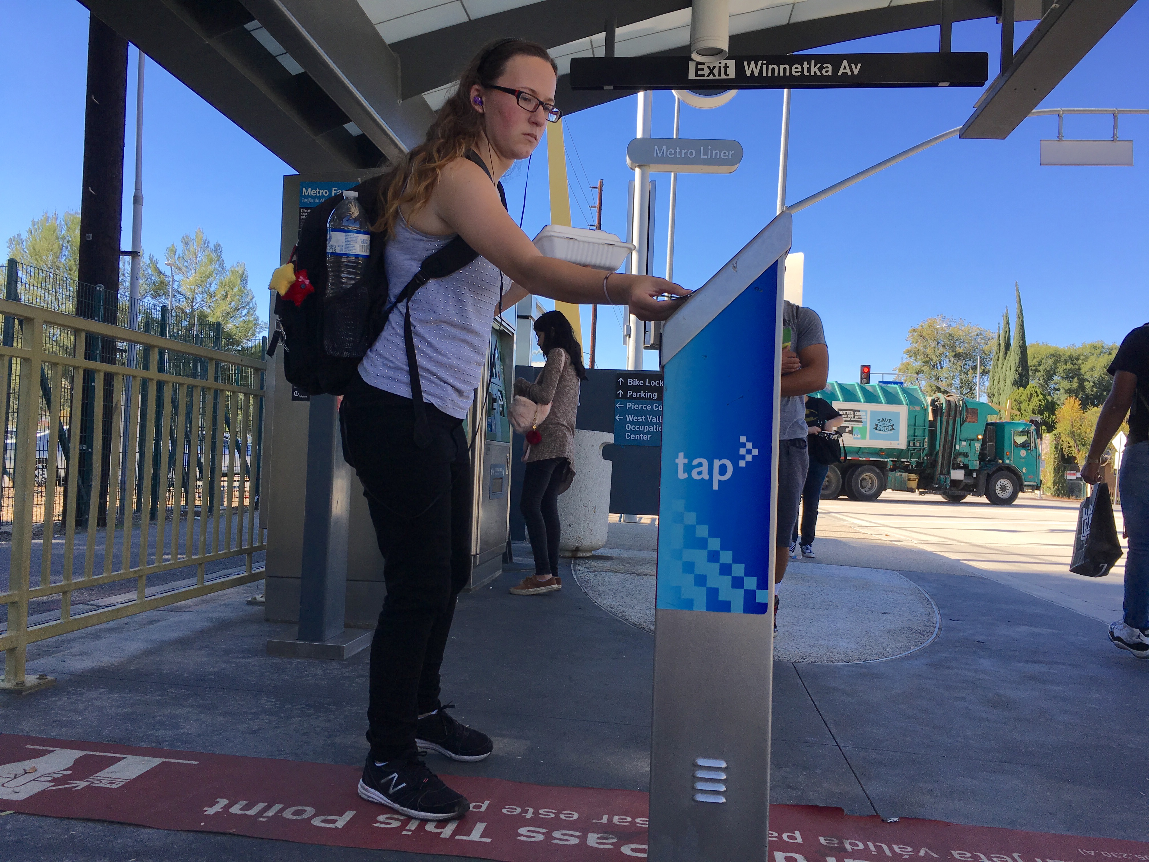 Pierce student, Alec Bick, 20, uses her student monthly tap card at the Winnetka Orange Line station in Woodland Hills, Calif. on Tuesday, Nov. 8. Students are required to have a class schedule of 12 units to get a reduced student card. President of ASO Barbara Lombrano, is pushing to lower the requirements to 6 units. Photo by Mohammad Djauhari